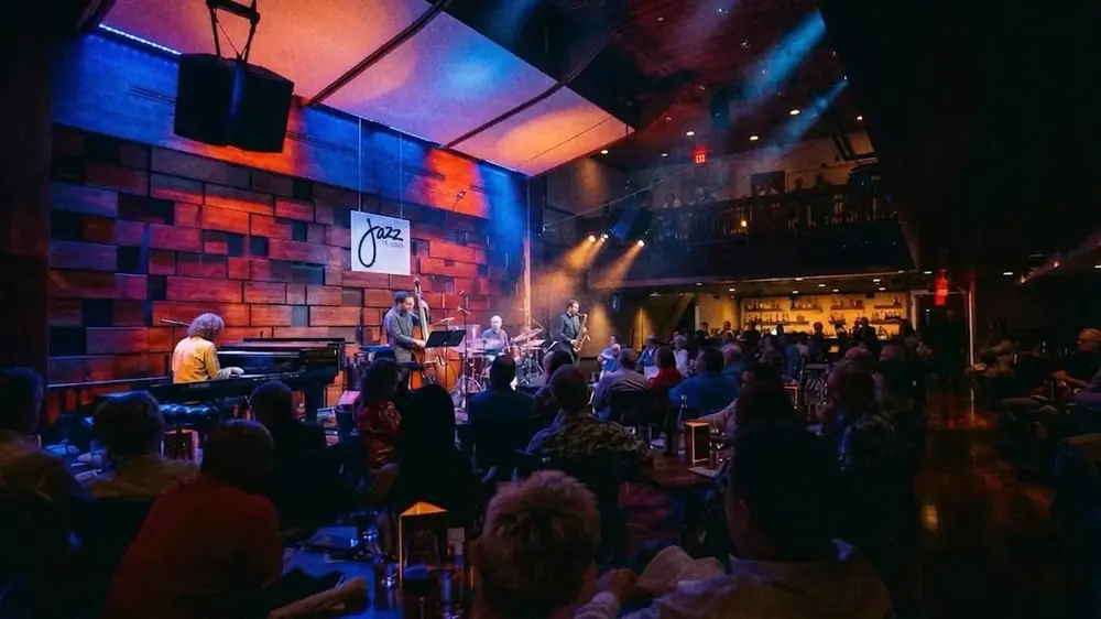 Frame from a Jazz St. Louis concept: a full house watching a band on stage